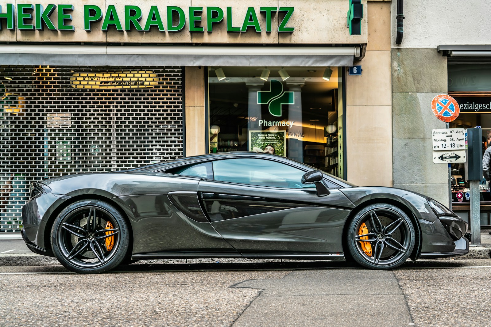 gray sports coupe parking beside store